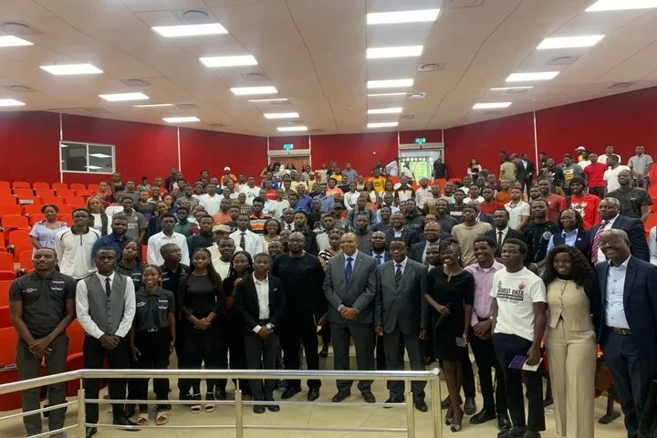 BOZ Governor and UNZA Vice Chancellor pose for a photo with students after a public lecture